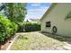 Backyard featuring a tidy lawn, mature hedges, and privacy fencing at 1187 Mistwood Dr, Tarpon Springs, FL 34688