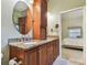 Bathroom with granite countertops, wood cabinetry, and access to bedroom at 1187 Mistwood Dr, Tarpon Springs, FL 34688