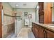 Bathroom featuring walk-in shower, vanity with granite counters, and stylish fixtures at 1187 Mistwood Dr, Tarpon Springs, FL 34688