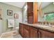 Bathroom vanity with granite counters, a framed mirror, and ample storage space at 1187 Mistwood Dr, Tarpon Springs, FL 34688