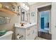 Bright bathroom featuring a vanity with marble countertop, updated fixtures, and decor shelves at 1187 Mistwood Dr, Tarpon Springs, FL 34688