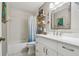 Modern bathroom featuring a bathtub with a shower, vanity with marble countertop, and updated fixtures at 1187 Mistwood Dr, Tarpon Springs, FL 34688
