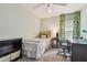 Bright bedroom featuring a twin bed, desk, chair, and colorful curtains, perfect for a or guest at 1187 Mistwood Dr, Tarpon Springs, FL 34688