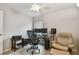 Functional home office featuring dual monitors, office chair, and a comfortable armchair for relaxation at 1187 Mistwood Dr, Tarpon Springs, FL 34688