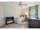 Cozy bedroom featuring a twin bed, desk, chair, and colorful curtains, perfect for a or guest at 1187 Mistwood Dr, Tarpon Springs, FL 34688