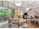 Dining area with seating and view of the outdoor patio and living room at 1187 Mistwood Dr, Tarpon Springs, FL 34688