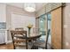 Cozy dining area with round table and chairs, with access to the outdoor screened in lanai at 1187 Mistwood Dr, Tarpon Springs, FL 34688