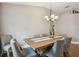 Charming dining room features a rustic wooden table, seating for six, and a modern chandelier at 1187 Mistwood Dr, Tarpon Springs, FL 34688