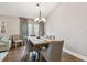 Inviting dining area with a wooden table, six chairs, and elegant lighting fixture at 1187 Mistwood Dr, Tarpon Springs, FL 34688