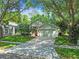 Single-Gathering home with a manicured lawn and mature landscaping and shade trees at 1187 Mistwood Dr, Tarpon Springs, FL 34688