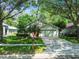 Single-Gathering home with a long driveway and mature trees providing shade over the lawn at 1187 Mistwood Dr, Tarpon Springs, FL 34688