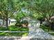 Lovely view of this single-Gathering home with manicured lawn, mature landscaping, and shade trees at 1187 Mistwood Dr, Tarpon Springs, FL 34688