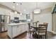Bright kitchen with a center island, stainless steel appliances, and adjacent dining area at 1187 Mistwood Dr, Tarpon Springs, FL 34688