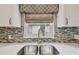Close-up of the kitchen sink, showcasing the faucet, counter and window at 1187 Mistwood Dr, Tarpon Springs, FL 34688