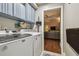 Convenient laundry room includes washer, dryer, cabinets and is connected to the living area at 1187 Mistwood Dr, Tarpon Springs, FL 34688