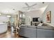 Comfortable living area with hardwood floors, modern sofa, and an adjacent dining area at 1187 Mistwood Dr, Tarpon Springs, FL 34688