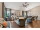 Comfortable living room featuring hardwood floors, neutral paint, ceiling fan, and dining area at 1187 Mistwood Dr, Tarpon Springs, FL 34688