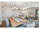 Open-concept living and dining areas feature hardwood floors, modern lighting, and comfortable seating at 1187 Mistwood Dr, Tarpon Springs, FL 34688