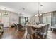 Bright living and dining areas feature hardwood floors, a ceiling fan, and elegant furnishings at 1187 Mistwood Dr, Tarpon Springs, FL 34688
