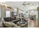 Open-concept living room with modern furnishings, hardwood floors, and seamless flow to the kitchen at 1187 Mistwood Dr, Tarpon Springs, FL 34688