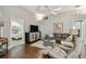 Inviting living room with hardwood floors, a modern entertainment center, and views into the bedroom at 1187 Mistwood Dr, Tarpon Springs, FL 34688