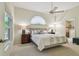 Comfortable main bedroom with ample natural light, ceiling fan and an ensuite bathroom at 1187 Mistwood Dr, Tarpon Springs, FL 34688
