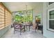 Screened lanai offers a relaxing outdoor space with seating and serene views of the surrounding greenery at 1187 Mistwood Dr, Tarpon Springs, FL 34688