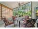 Charming screened patio with comfortable seating offering beautiful views of the serene backyard at 1187 Mistwood Dr, Tarpon Springs, FL 34688