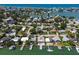 Aerial view of home showing location on the water with boat dock and neighborhood at 14043 E Parsley Dr, Madeira Beach, FL 33708
