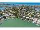 Stunning aerial view of a waterfront home with private dock and lush landscaping nestled by the serene water at 14043 E Parsley Dr, Madeira Beach, FL 33708
