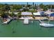 Waterfront home with lush landscaping, private boat dock, and patio seating, perfect for outdoor entertaining at 14043 E Parsley Dr, Madeira Beach, FL 33708