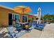 Outdoor patio with patio set, sun umbrella and lounge chair for outdoor living at 14043 E Parsley Dr, Madeira Beach, FL 33708