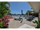 Outdoor patio with comfortable seating, lush plants, and boat dock access, perfect for waterfront relaxation at 14043 E Parsley Dr, Madeira Beach, FL 33708