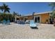 Backyard featuring outdoor seating area and sliders to enter home. Ideal for outdoor waterfront living at 14043 E Parsley Dr, Madeira Beach, FL 33708