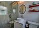 Modern bathroom showcasing a vessel sink, walk-in shower with glass door, and contemporary fixtures at 14043 E Parsley Dr, Madeira Beach, FL 33708