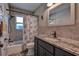 Well-lit bathroom featuring granite countertops, grey tiled walls, and updated fixtures at 14043 E Parsley Dr, Madeira Beach, FL 33708