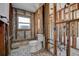 Under-renovation bathroom with a window and gray mosaic tile flooring, offering renovation potential at 14043 E Parsley Dr, Madeira Beach, FL 33708