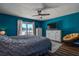 Comfortable bedroom features an accent wall, water view, seating, and updated furnishings at 14043 E Parsley Dr, Madeira Beach, FL 33708