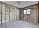 Bedroom features framed concrete block walls, a single window, and hardwood floors at 14043 E Parsley Dr, Madeira Beach, FL 33708