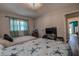 Bright bedroom features two twin beds, a view of the outside, and a glimpse of the hall at 14043 E Parsley Dr, Madeira Beach, FL 33708
