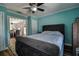 Stylish bedroom with a tufted headboard bed, and doorway leading to the dining area at 14043 E Parsley Dr, Madeira Beach, FL 33708