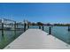 Close-up view of a private boat dock showcasing the dock's construction and the beautiful waterfront scenery at 14043 E Parsley Dr, Madeira Beach, FL 33708