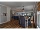 Open-concept dining area with a table, upholstered chairs, and views into the kitchen and living room at 14043 E Parsley Dr, Madeira Beach, FL 33708