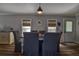 Charming dining area with seating, wood-look floors, and subtle nautical decor touches at 14043 E Parsley Dr, Madeira Beach, FL 33708