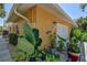 Exterior view of the home with garage, landscape and updated front exterior at 14043 E Parsley Dr, Madeira Beach, FL 33708