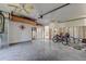 Spacious garage with multiple ceiling fans, upper shelving, and bicycles at 14043 E Parsley Dr, Madeira Beach, FL 33708