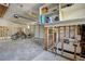 Spacious garage with ceiling fans, upper shelving, and framed bathroom offering potential for a customized space at 14043 E Parsley Dr, Madeira Beach, FL 33708