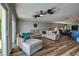 Spacious living room with wood floors, ceiling fan, sliding glass doors, and modern decor at 14043 E Parsley Dr, Madeira Beach, FL 33708