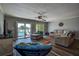 Bright living room with sliding glass doors leading to the backyard and comfortable seating at 14043 E Parsley Dr, Madeira Beach, FL 33708