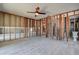 Living room features exposed wood framing with doorway openings and a ceiling fan for comfortable living at 14043 E Parsley Dr, Madeira Beach, FL 33708